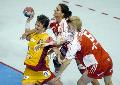 Romania's Valeria Bese (L) tries to score despite Hungary's Zsuzsanna Tomori (C) and Orsolya Verten